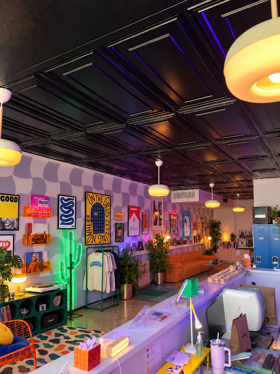 Lakeland Film Lab: the full shop interior with a long counter, gallery walls, and pendant lights